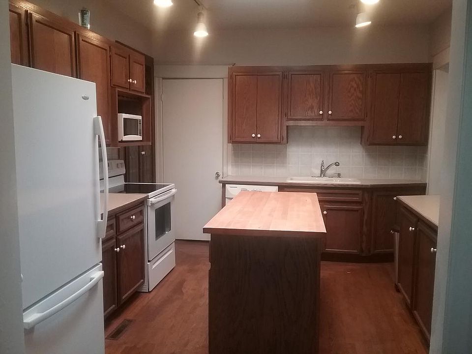 Kitchen, picture from dining room. Lots of cupboards.