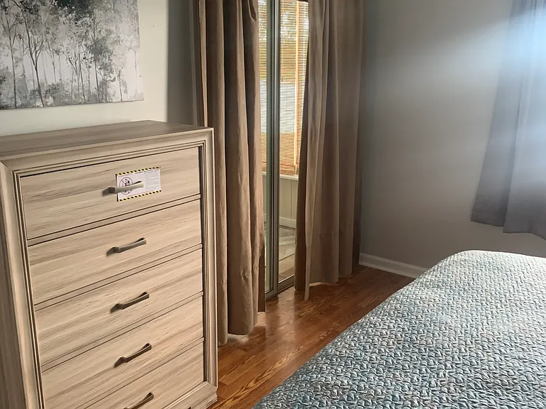 Master bedroom, full chest of drawers; nice drapes and wall picture