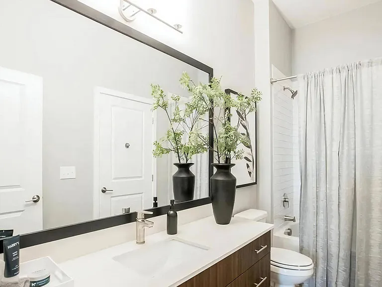 Spacious bathroom with contemporary fixtures, single-sink vanity, and neutral-toned design