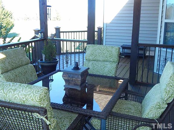Covered beautiful porch with new composite wood flooring and aluminum balusters