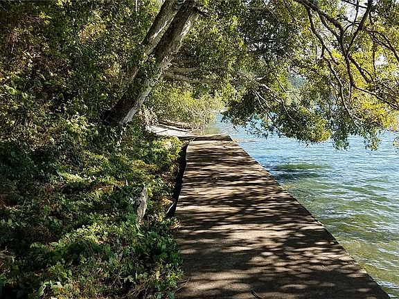 View of bulk head looking South, away from boathouse at high tide. 