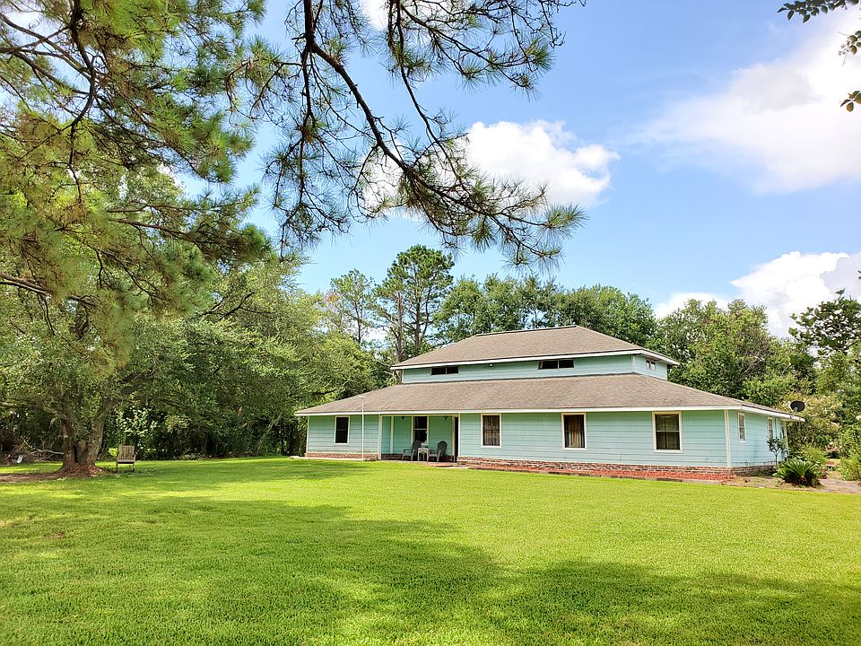 A tranquil retreat surrounded by mature trees and lush greenery. Enjoy peaceful country living on a beautifully maintained lot with endless space to relax or entertain.