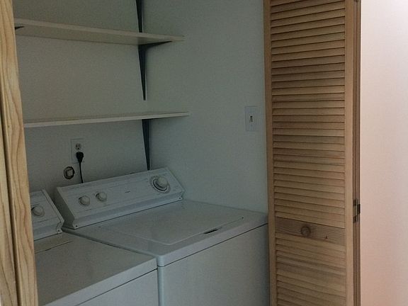 Washer/ dryer behind slatted doors to left of entry