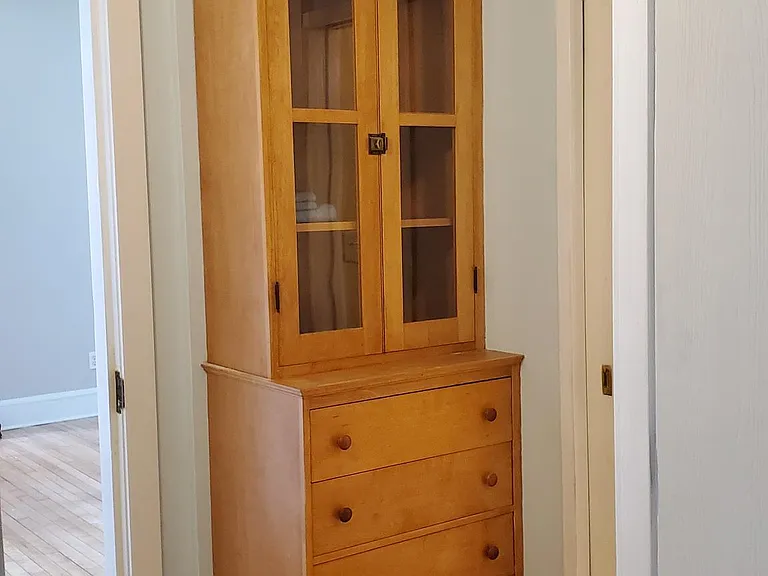 A built-in hutch is located in the hall next to the bathroom.