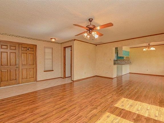 view of living room and dining, looking toward front door.