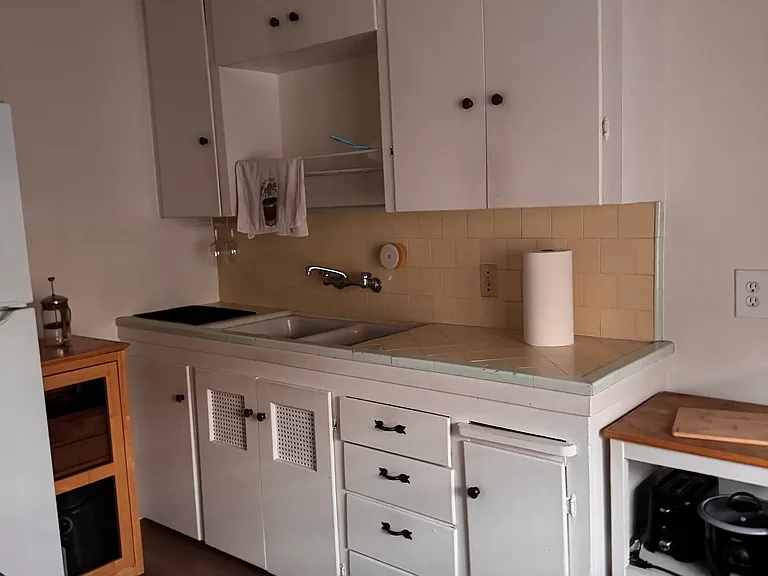 Kitchen cabinets are generous for a studio apartment
