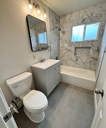 Newly remodeled bathroom; porcelain tiled floor and shower/tub combo. Vanity with plenty of storage.