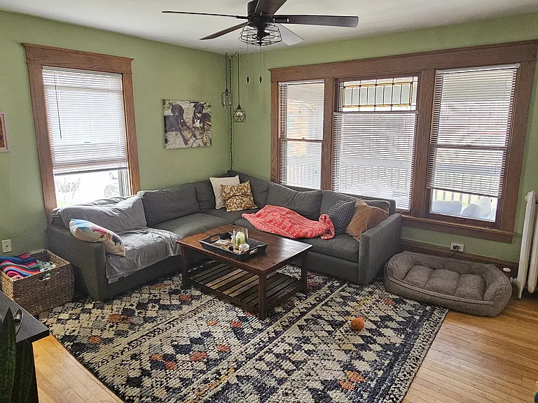 Downtown facing living room with stain glass window