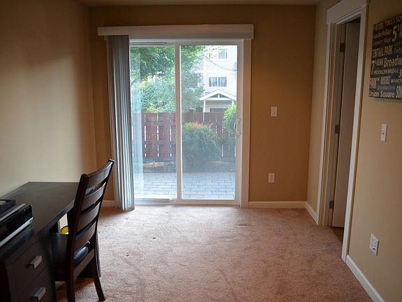 First floor bedroom with large closet, 3/4 bathroom, and sliding glass door to the private patio.