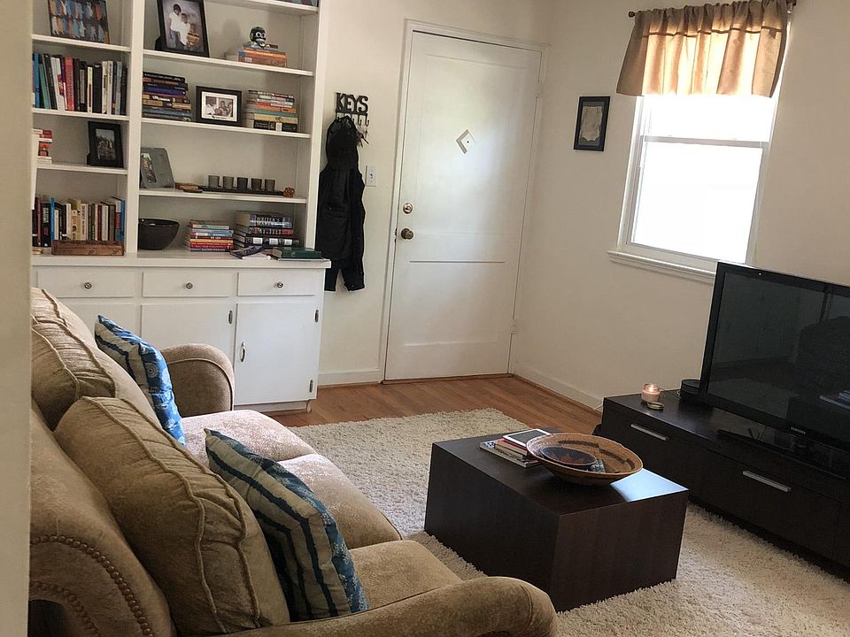 living room front door and bookshelves
