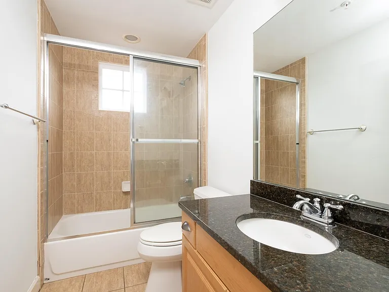 2nd bathroom with ceramic tile and granite vanity.