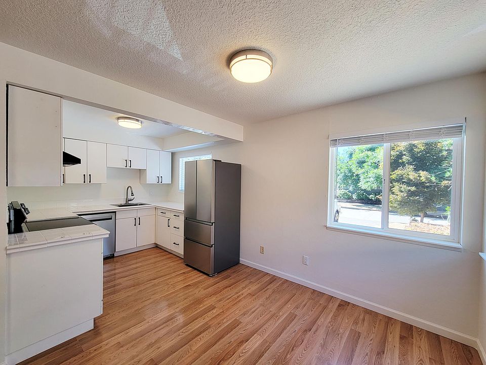 Kitchen with large, bright windows and stainless steel appliances
