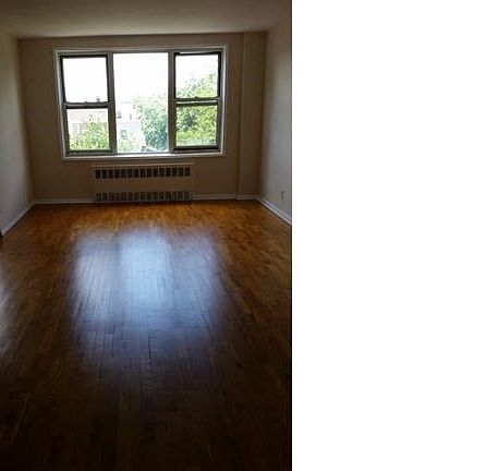 Sunny living room with plenty of floor and wall space
