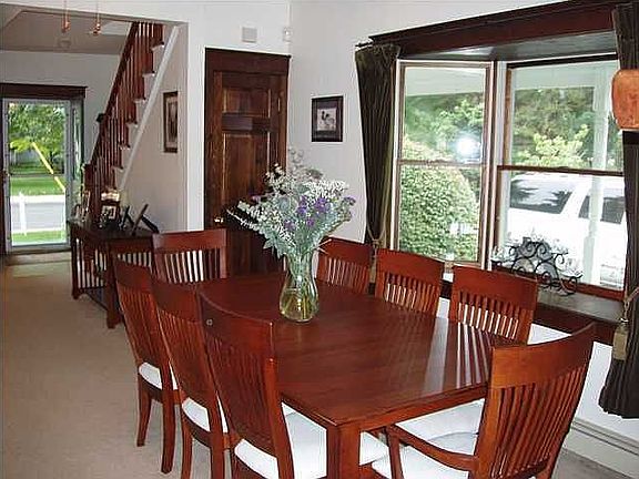 Expansive dining room with bay window and decorative moulding