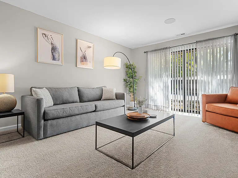 Spacious Living Room with Sliding Glass Door at Lakeside Village Apartments Clinton Township MI