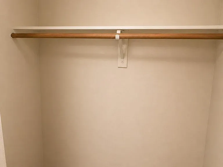 Dedicated closet space with a hanging rod and shelf to keep clothing and essentials organized and easy to access.