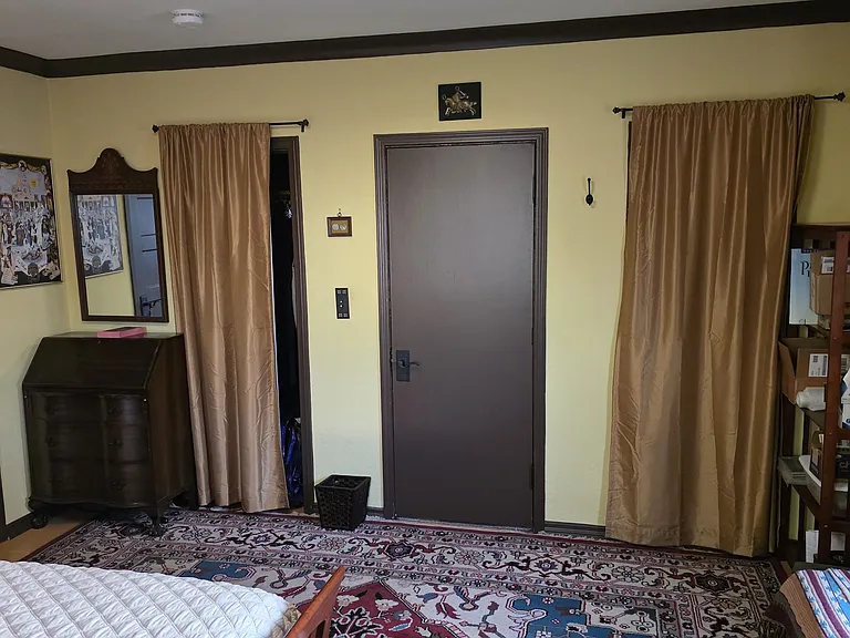 Primary bedroom. Closets are behind the curtains.