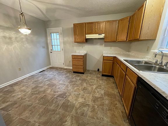 Kitchen includes stainless steel appliances including a stove, dishwasher, and refrigerator