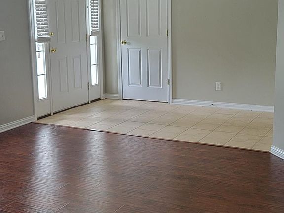 The entry area/ front door and open living area. Coat closet near entry way.