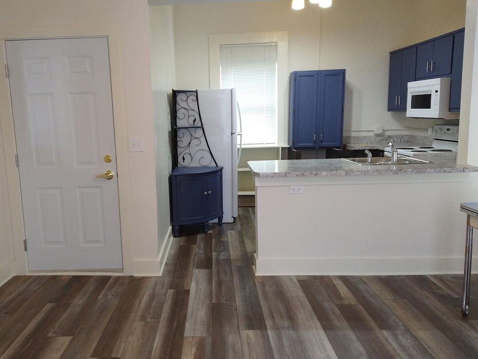 Inside view of front door, kitchen with peninsula overlooking living area.