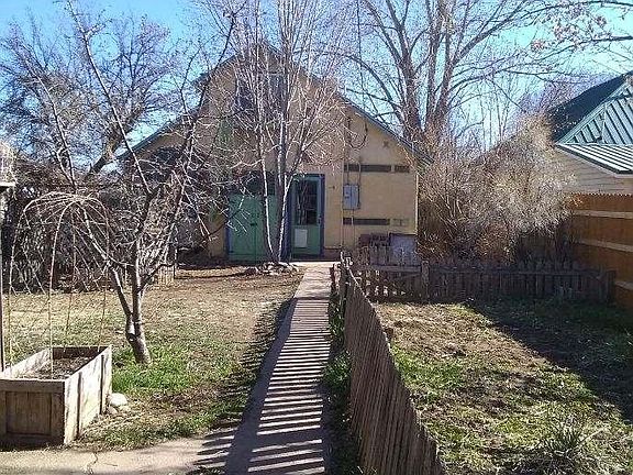 Backyard with fenced garden area on right