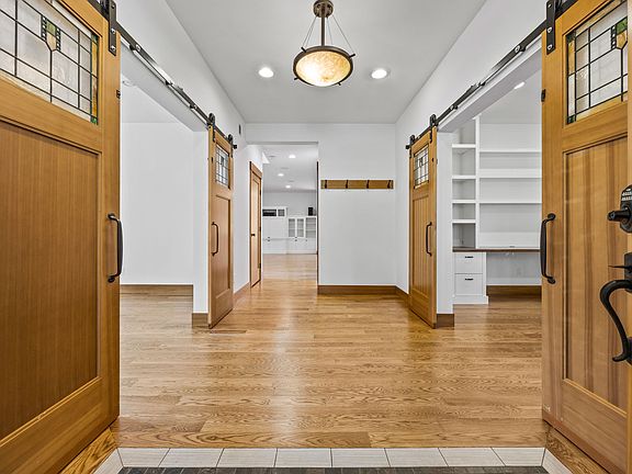 Inviting entryway with fresh paint and newly finished hardwood floors.