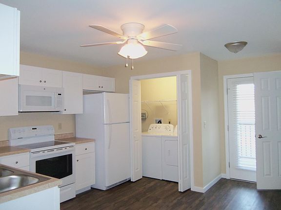 Spacious kitchen with laundry and door access to nice balcony.