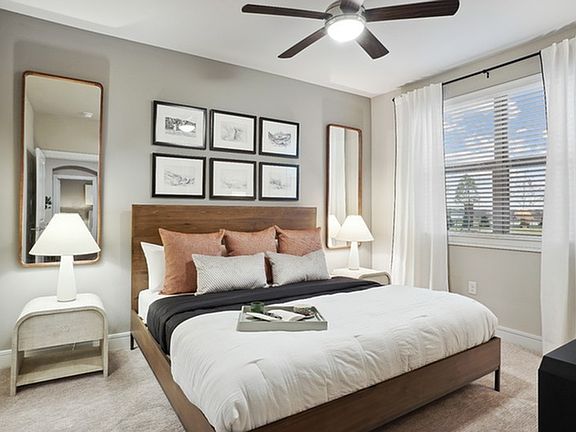 Large bedroom with ample natural lighting and ceiling fan