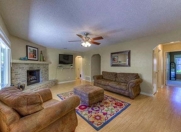 Family features a brick corner fireplace.