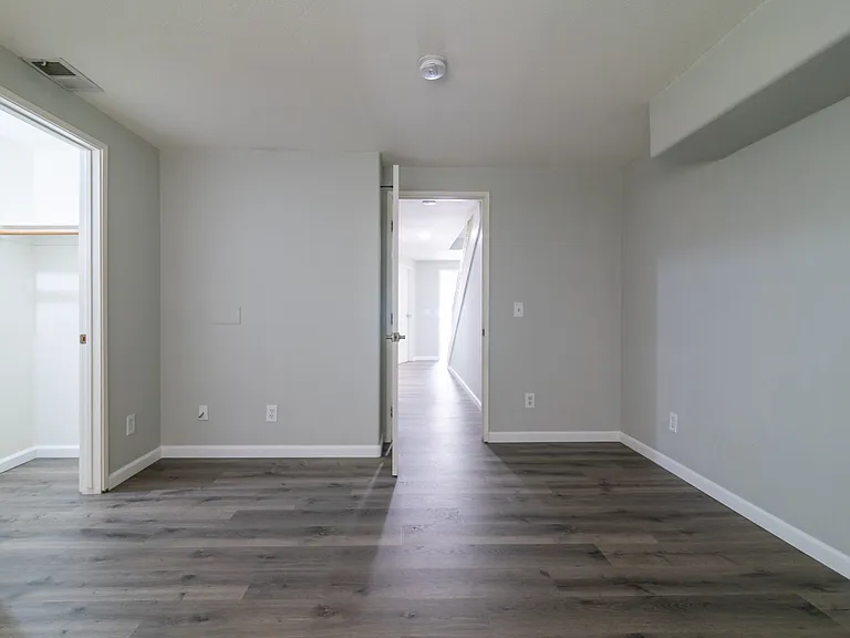 1st floor bedroom view to walk-in closet, hallway and front door & garage entry