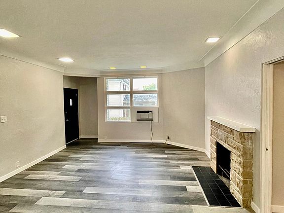 Second entrance, new window unit, non-working fireplace