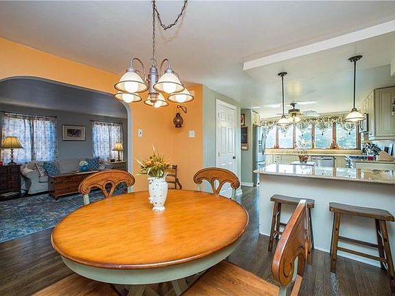 The dining room and kitchen are open to each other, creating a superb layout for entertaining. Bonus casual seating is found at 