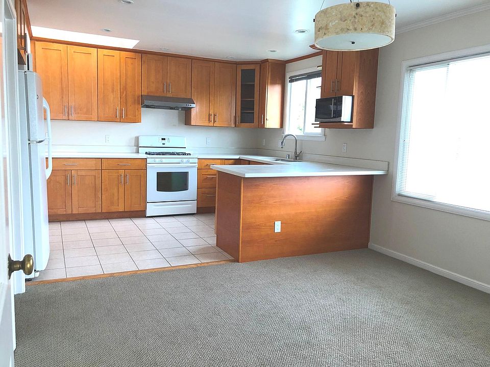 Bright kitchen with breakfast counter and view to the garden below