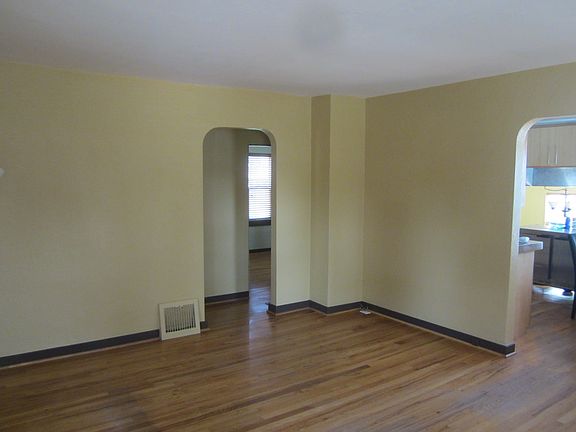 Left doorway off living room leads to two bedrooms and bathroom. Doorway to the right leads to kitchen and dining room.