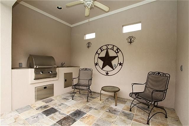 There are two covered patios, including this one that houses the outdoor kitchen.  The floors are lined with slate tiles and there are some windows to allow additional light without the heat of the day