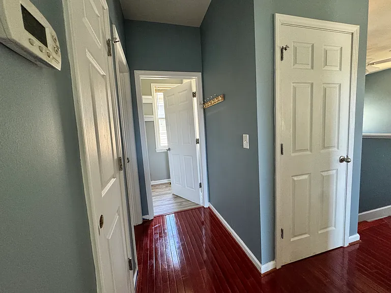Outside of the first bedroom, find two large storage closets, a convenient bathroom, and a laundry room right nearby. The hardwood floors run all the way through, maintaining a warm feel across the upstairs floor.