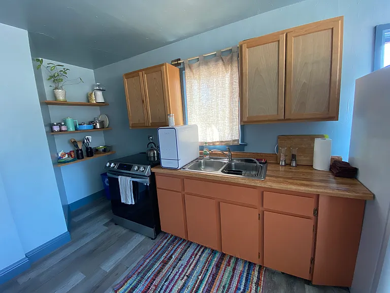 Full kitchen with microwave, oven, and small dishwasher