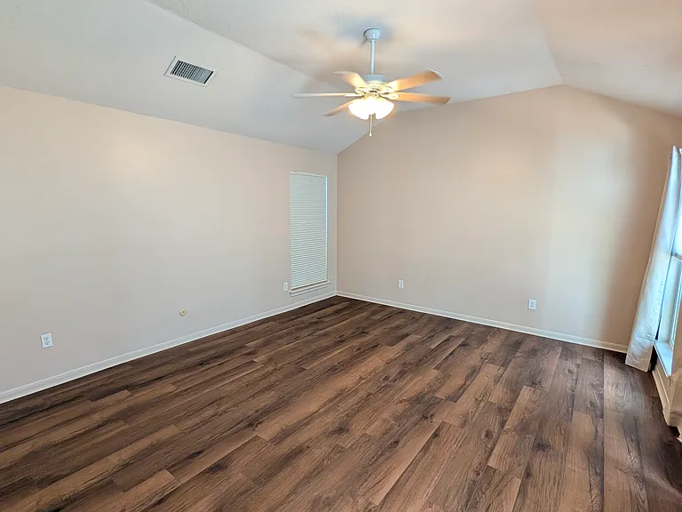 The main bedroom as it looks today with brand new luxury vinyl plank which is comfortable and quiet under foot. Blackout curtains and high/low blinds allow you to tailor light and privacy in your nest.