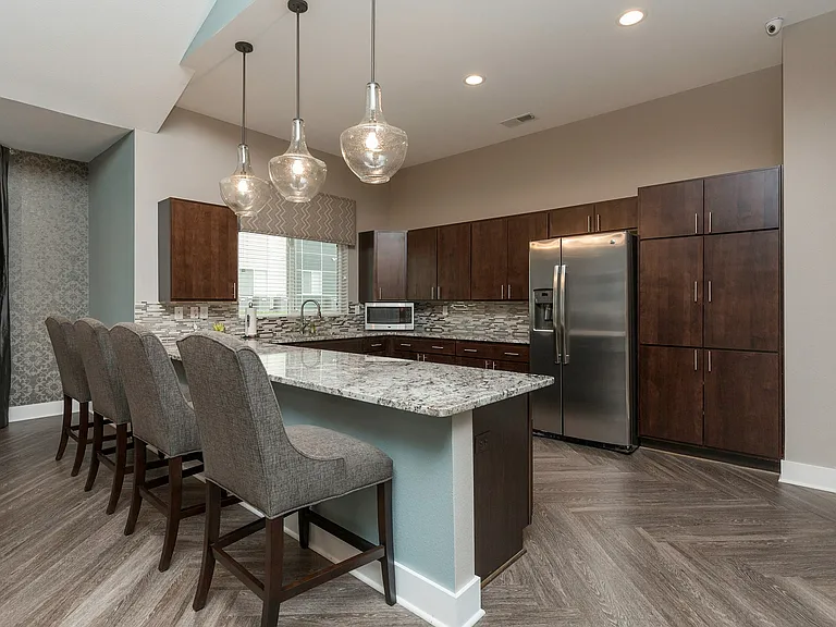 Enjoy the spacious, open-concept kitchen at Legacy Landing, complete with abundant cabinet storage and a breakfast bar with seating.