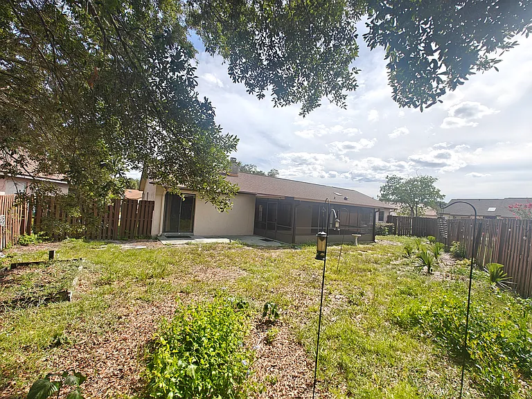 Fenced in backyard and screened back porch