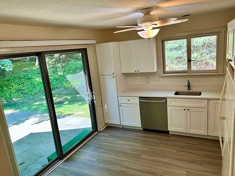 Sunny Kitchen with new cabinets and access to Patio.