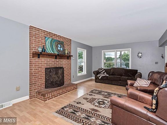 Living Room with Brick Fireplace and Sliding doors