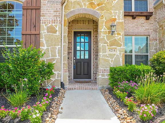 Notice the beautifully designed brick and stone elevation with professionally landscaped yard. This entry welcomes you home.