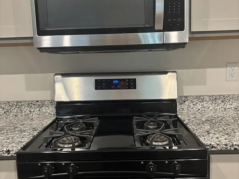Stainless microwave, black and stainless gas stove