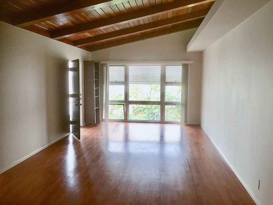 Entrance and large living room with huge window and high ceiling