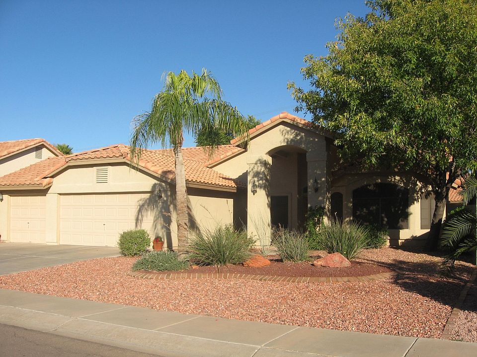 Exterioir front view- three car garage, front portico, large picture windows.