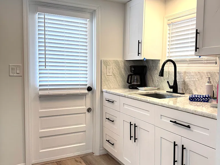 Kitchen entry off gated shell road.