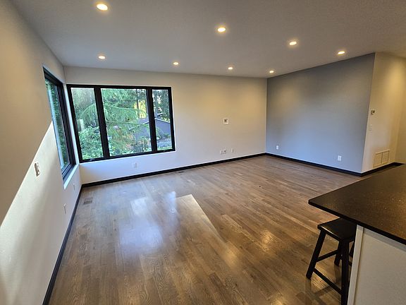 Living room with hardwood floors, lake view, and 9 foot ceilings