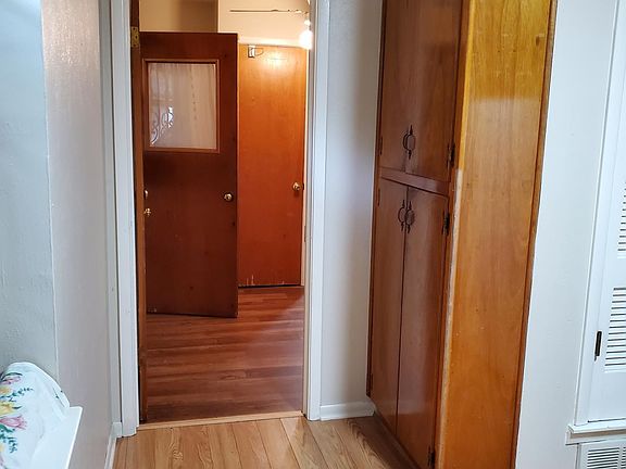 more cabinets in the kitchen - view leading to laundry and rear entrance