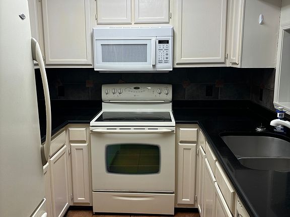 refrigerator, icemaker/freezer, range stove, microwave and dishwasher. Large double sink.
